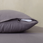 Close-up of a charcoal grey pillowcase featuring a concealed zipper closure, highlighting the secure fastening detail and soft, smooth fabric finish.
