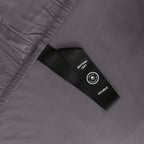 Close up of corner strap in gray bedding