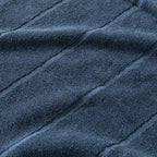 Close-up of textured blue fabric with folds.