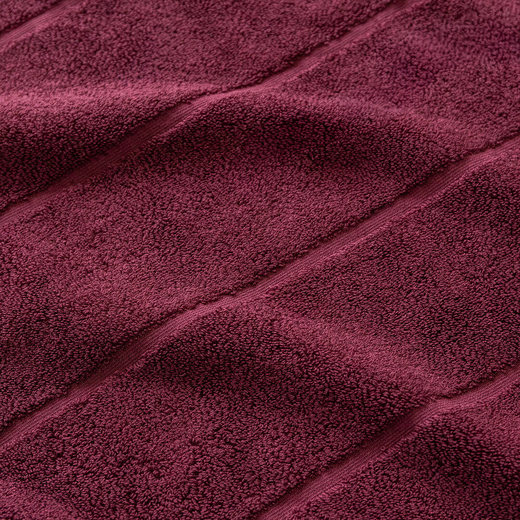 Close-up of maroon fabric with visible texture.