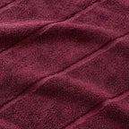 Close-up of maroon fabric with visible texture.