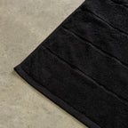 Black bath towel corner.