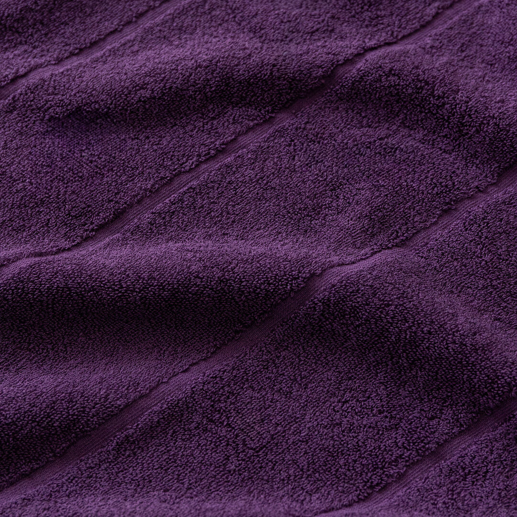 Close-up of purple textured fabric cotton towel.