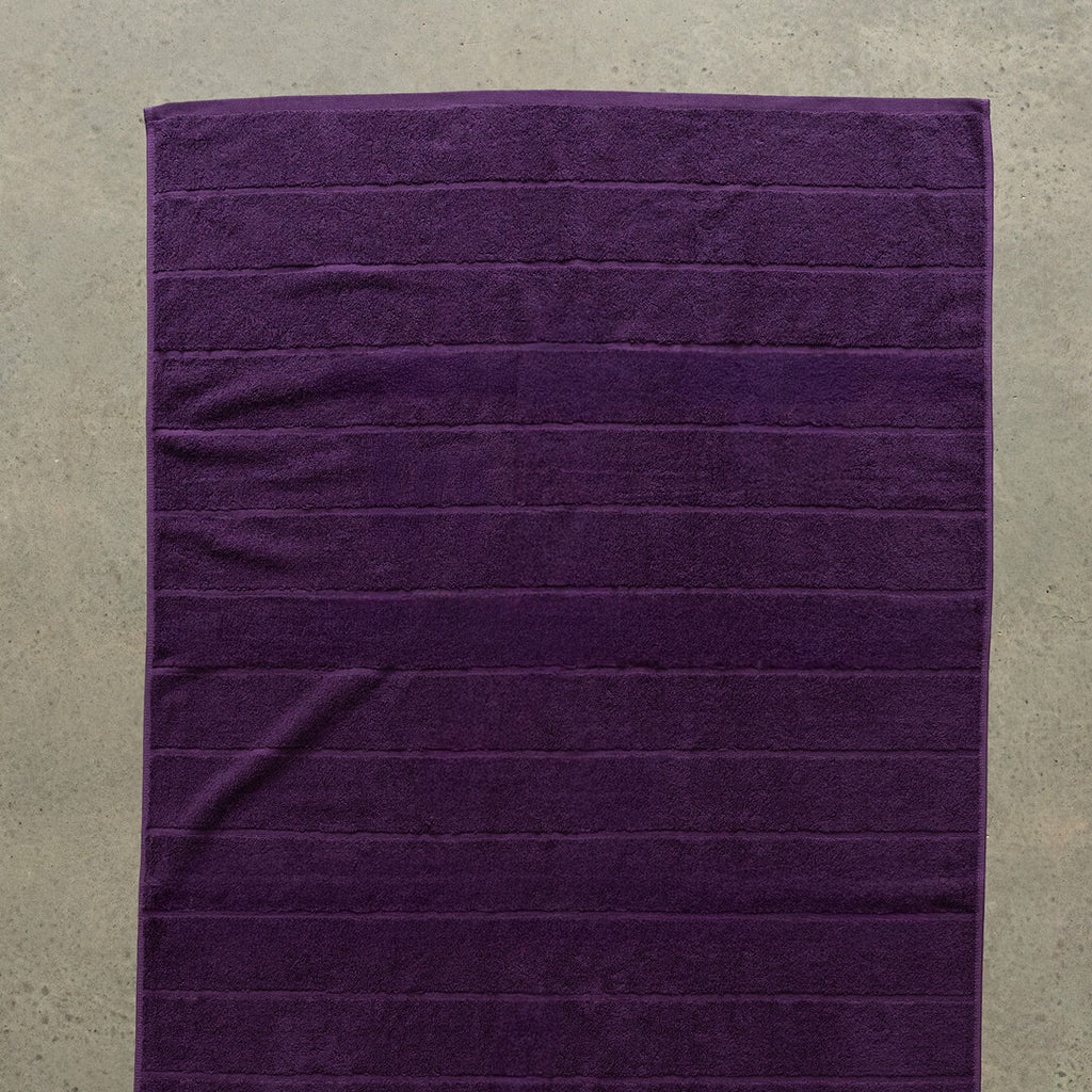 Purple towel on a beige surface.