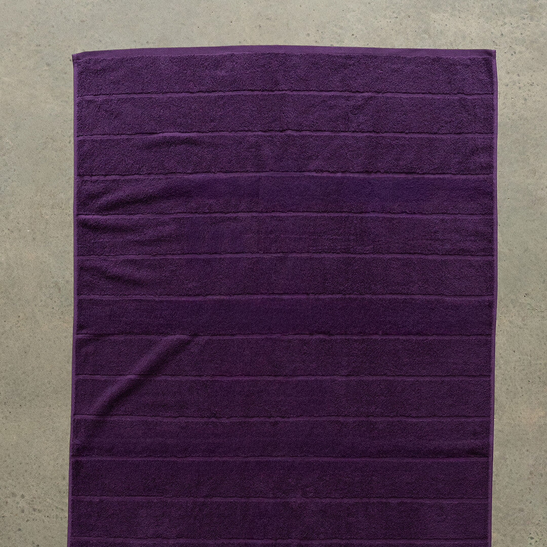 Purple towel on a beige surface.