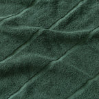 Close-up of textured green towel fabric with folds.