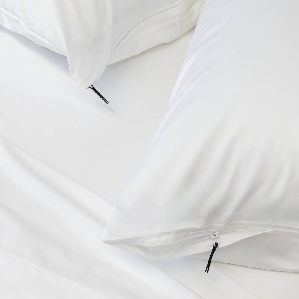 Close up of pillows with zips on white bedding