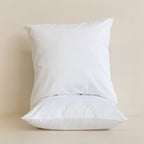 Two white pillows on a beige background
