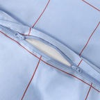 Close-up detail of a light blue grid-patterned quilt cover featuring a dual zipper closure