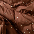 Brown fabric with white polka dots.