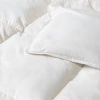 Close-up of white thick winter quilt insert, showing the magnetic corner.