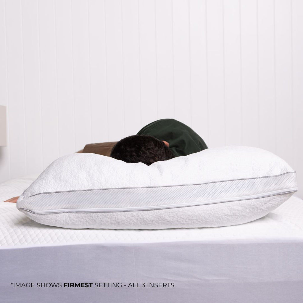 Person laying on bed with pillow