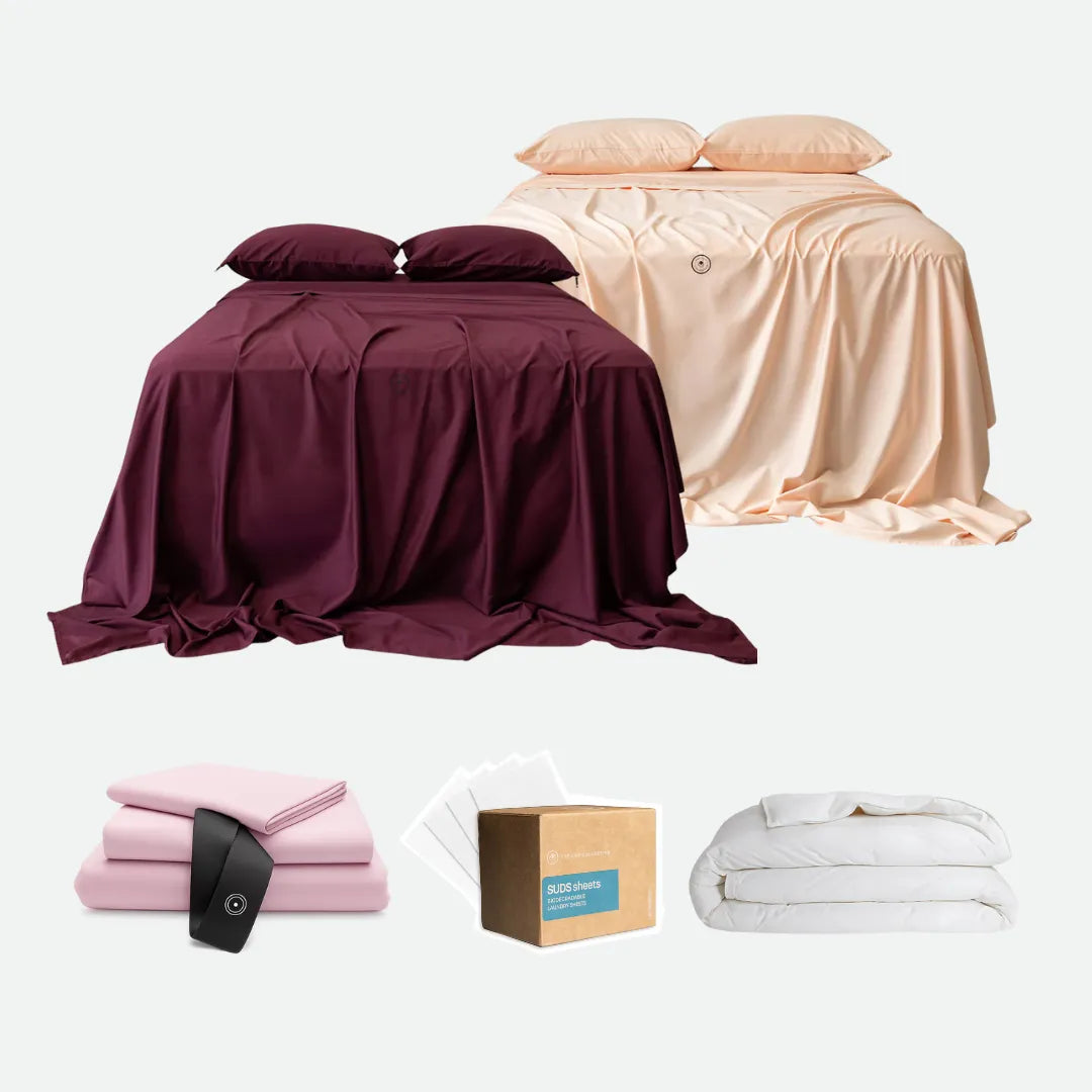 Collection of bed sheets, pillows, and a box on a white background
