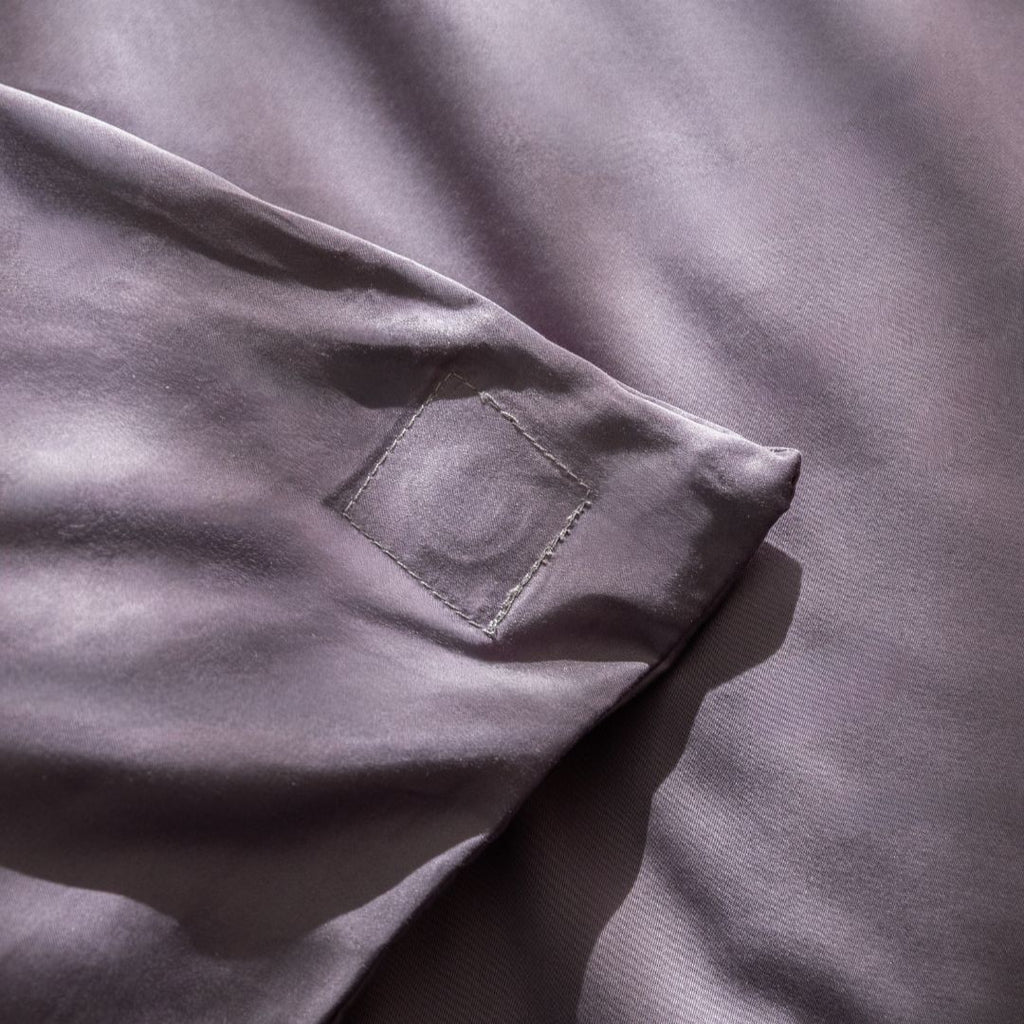 Close-up of a grey fabric with detail of stitching