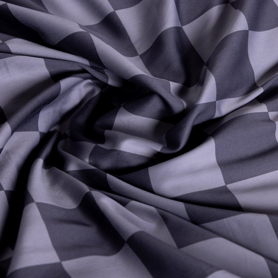 Checkered fabric pattern in shades of grey.