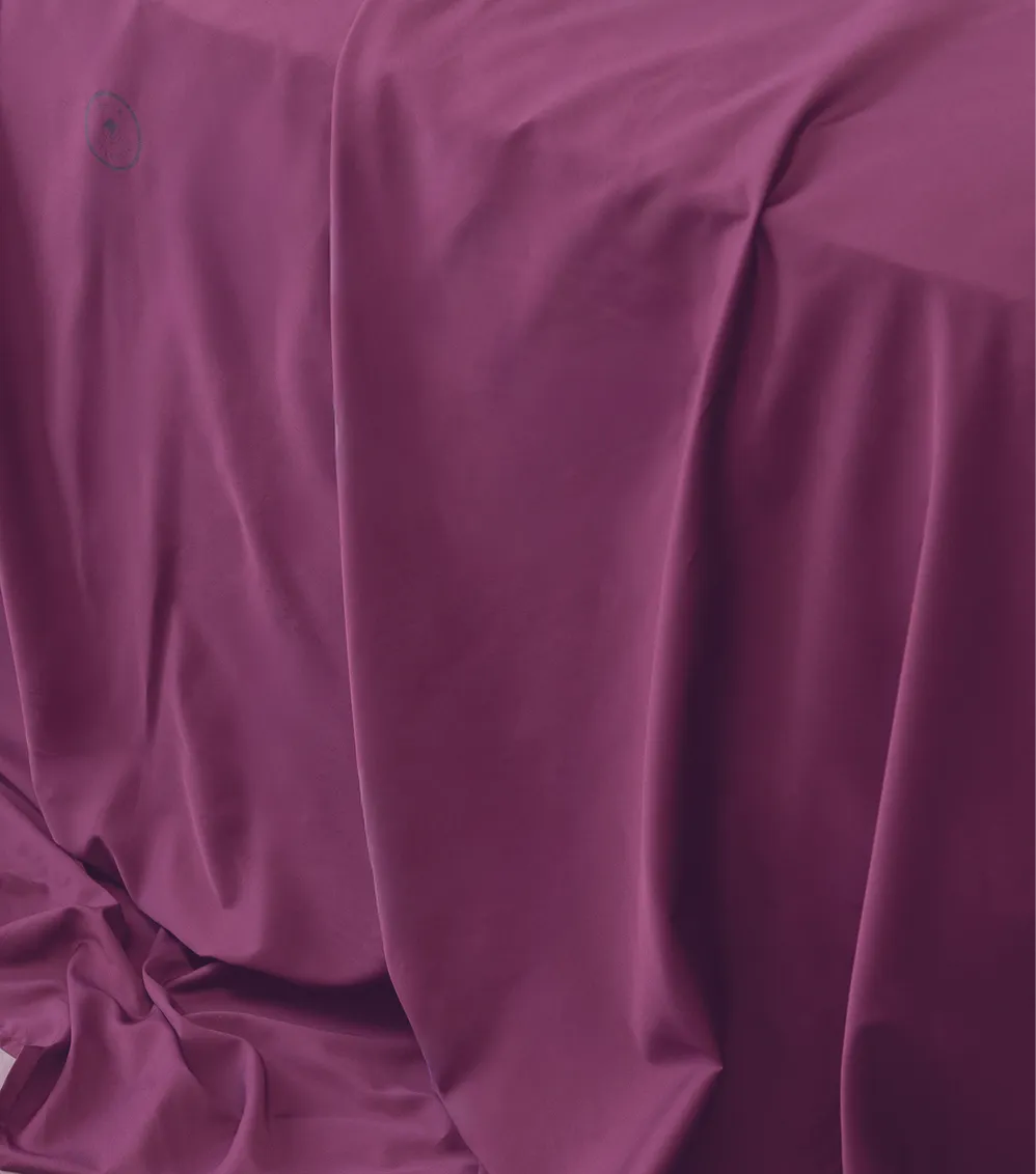 Plum-colored bed sheet with smooth, soft fabric and elegant drape.