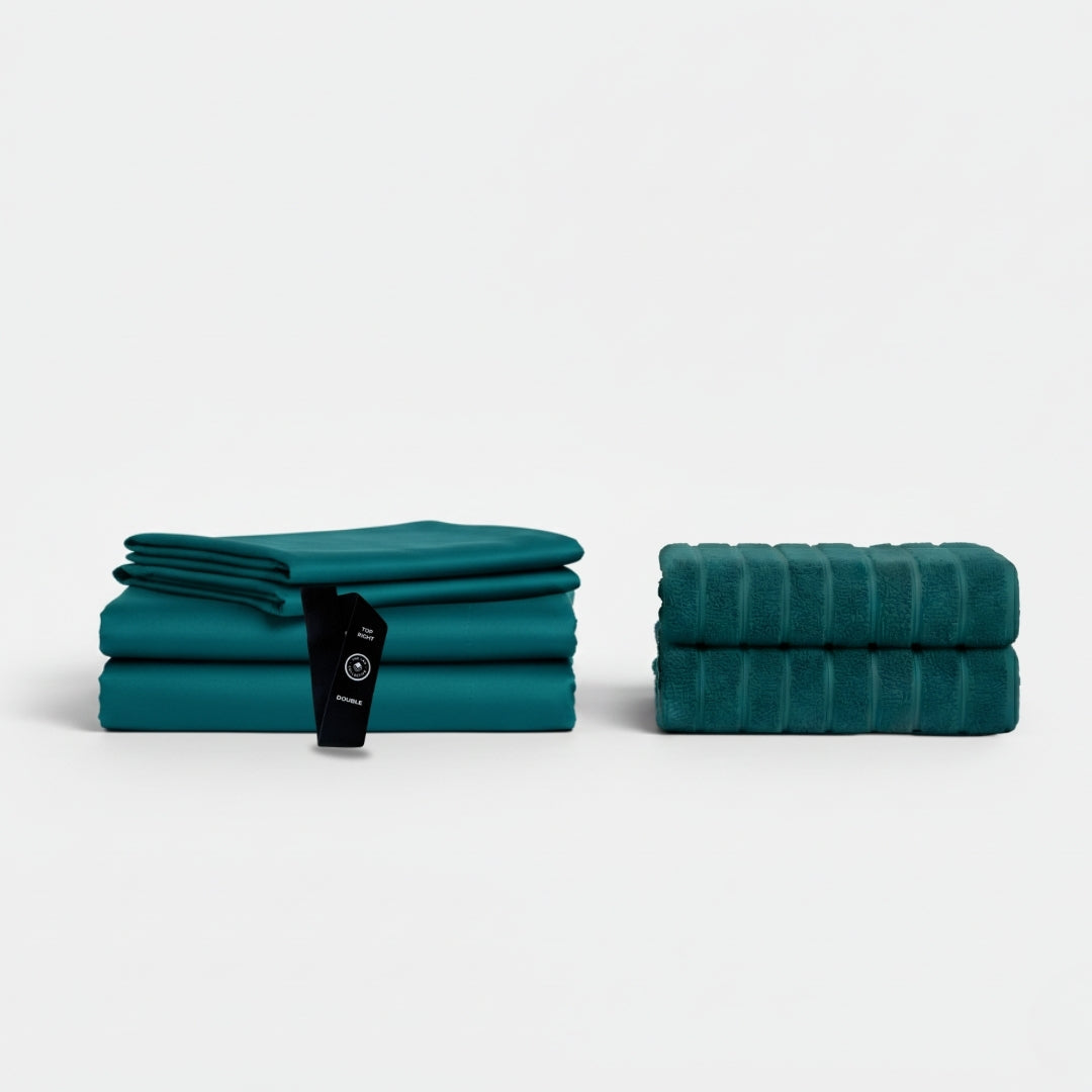 Folded Ningaloo bed sheets and matching teal bath towels displayed as a set.