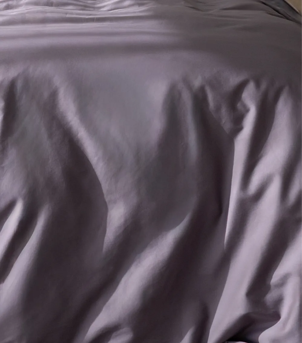 Close-up of purple satin fabric with a subtle pattern